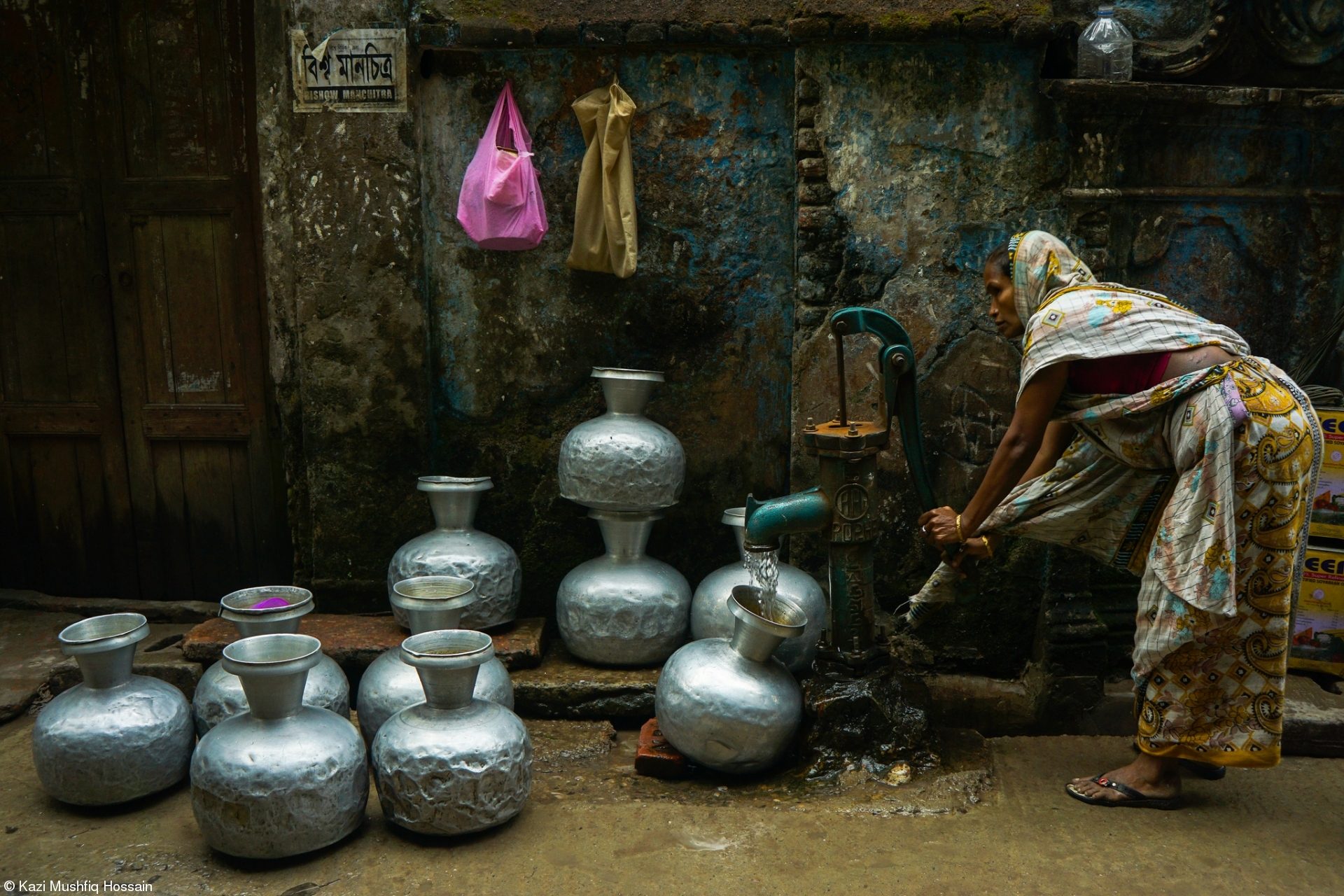 Water Collection From Street Pump by Kazi Mushfiq