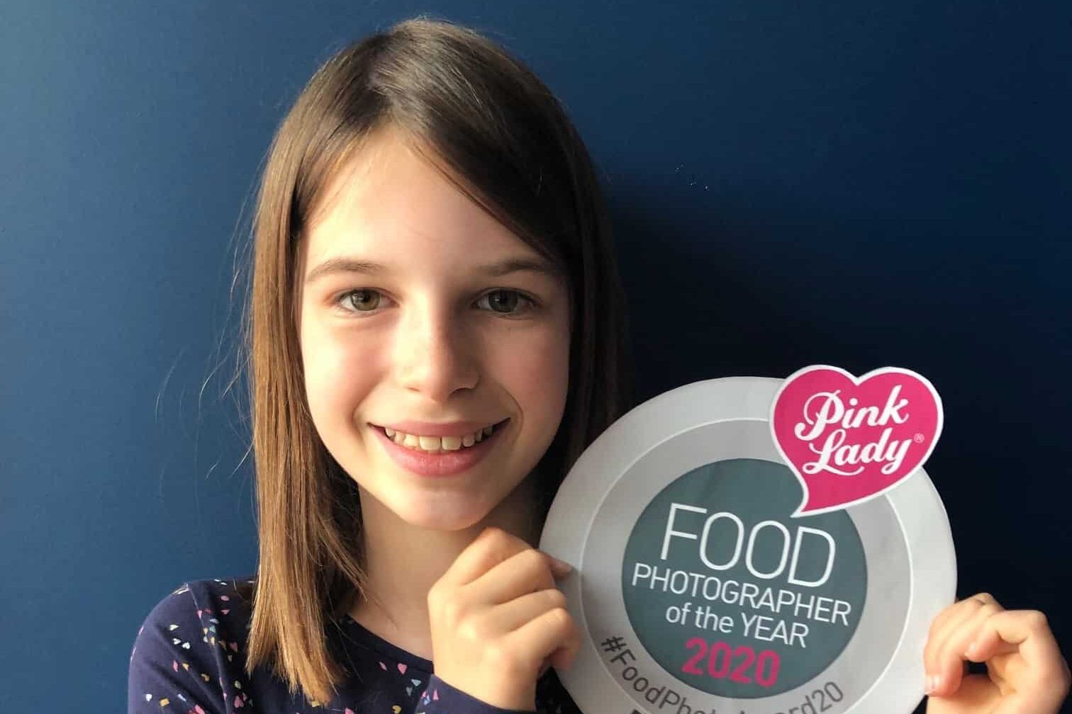 Young Person Holding Pink Lady Food Photographer Of The Year Logo